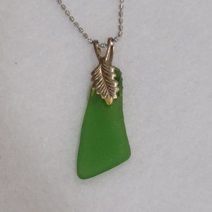 green sea glass pendant necklace on a silver tone chain